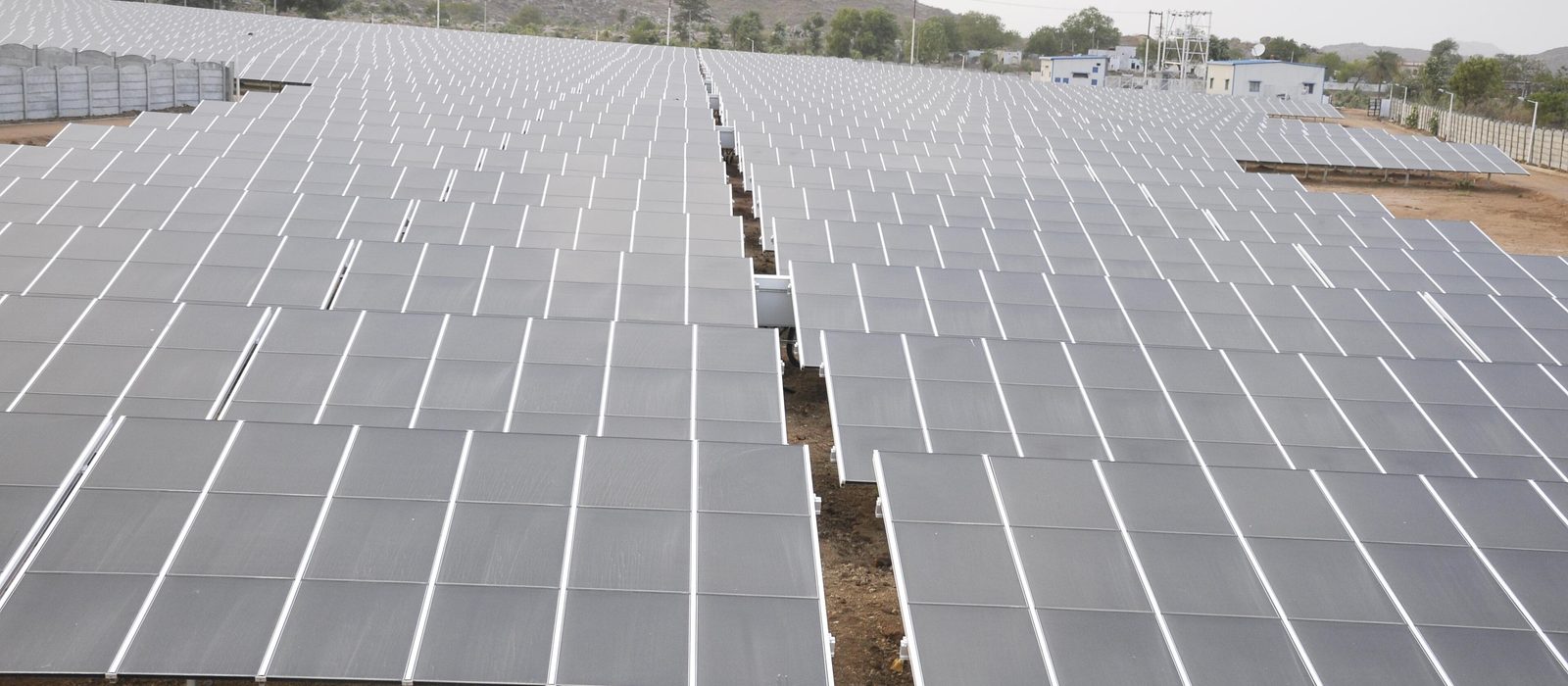 Rows of ground-mounted solar panels at a solar plant in India
