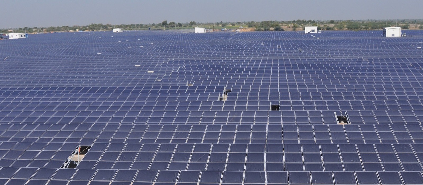 A large utility-scale solar plant in India stretching to the horizon