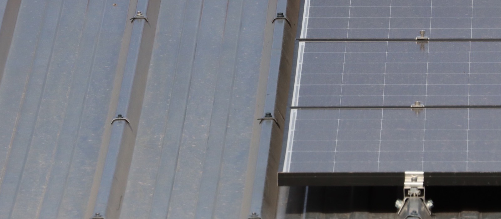 Solar panels mounted on the metal roof of a building